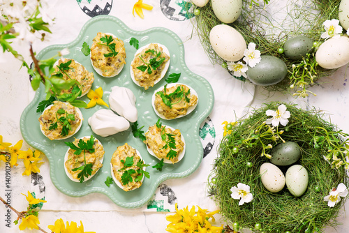 Easter deviled eggs with fried champignons on Easter background..top veiw
