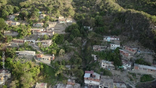 Wallpaper Mural A hillside community with scattered homes, lush greenery, and rugged terrain, looking towards maiquetía, aerial view Torontodigital.ca