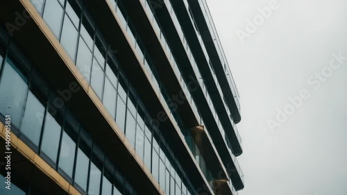 Wallpaper Mural Abstract Facade of a Tall Modern Architecture with Glass Windows and Neutral Concrete Texture Against Cloudy Sky Torontodigital.ca