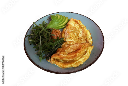 Fresh tasty omelette with arugula green salad, smoked salmon slices, avocado cut in pieces on trendy plated isolated image, selective focus close-up, cutout with clipping path morning meal object
