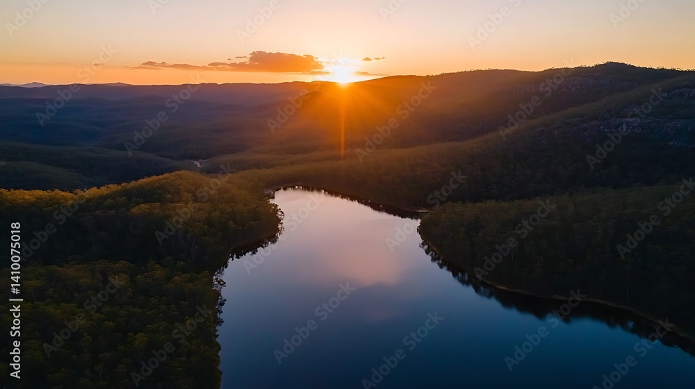 Fototapeta premium Serene sunset over a winding lake nestled in a valley.