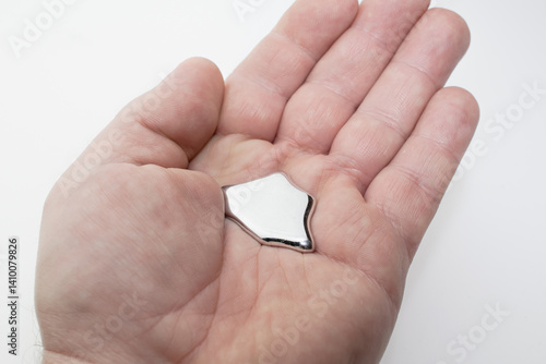 mercury liquid metal on hand, toxic and poison.