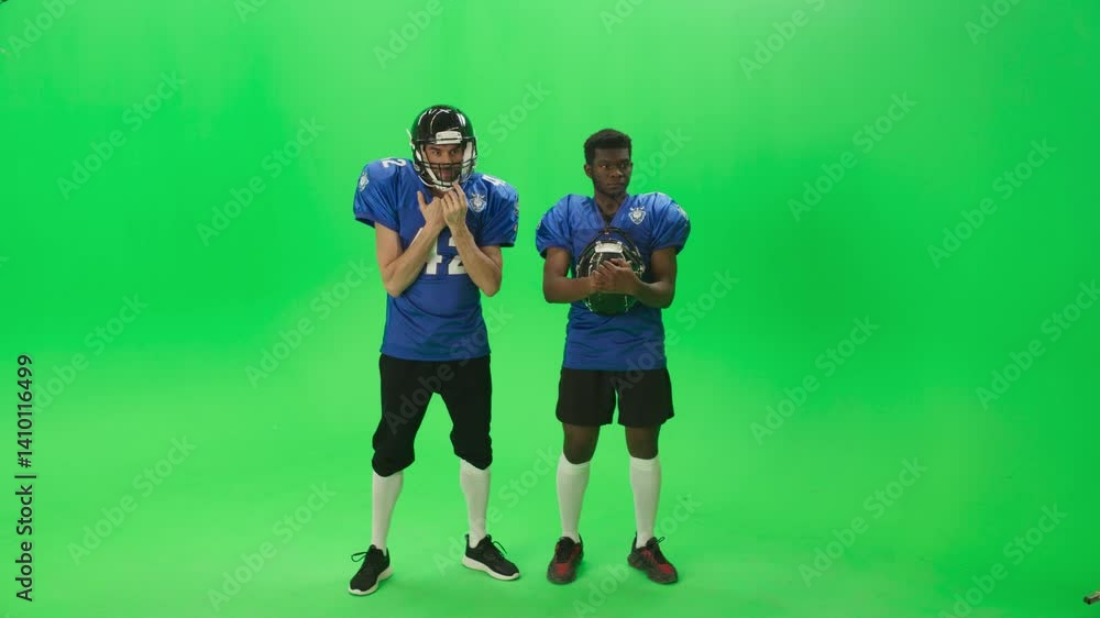 Green Screen Chroma Key Background: American Football Match with Two Substitute Players Cheering and Supporting Their Team in the Championship Ready to Go in Field and Win. Green Screen Chroma Key Background: American Football Match with Two Substitute Players Cheering and Supporting Their Team in the Championship Ready to Go in Field and Win.