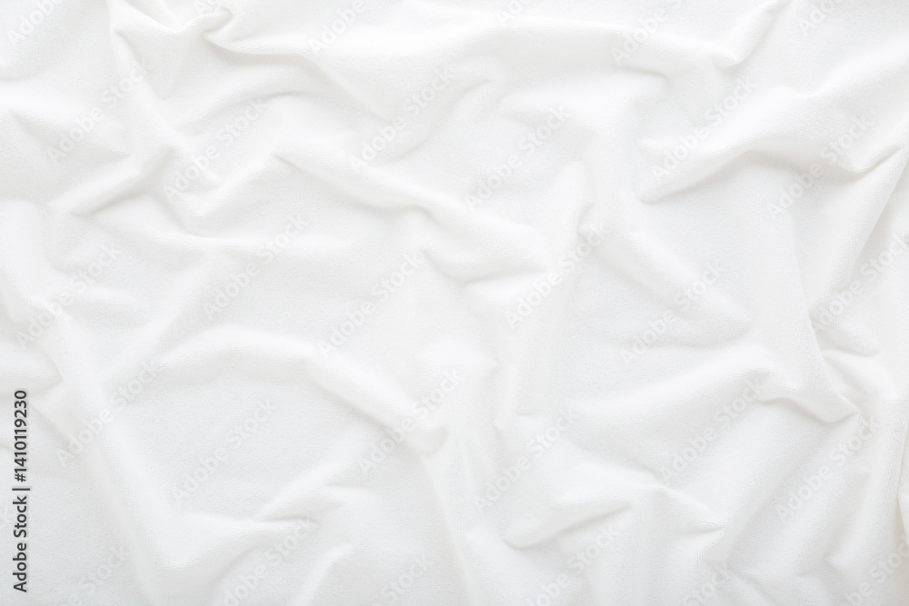 Obraz premium White wavy bed sheet background. Closeup. Top down view.