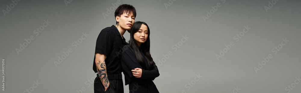 Fototapeta premium Stylish couple exudes love and romance in fashionable poses during modern studio shoot