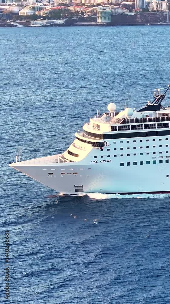 Cruise ship sails through stunning waters of Madeira at sunset. Vertical video Cruise ship sails through stunning waters of Madeira at sunset. Vertical video