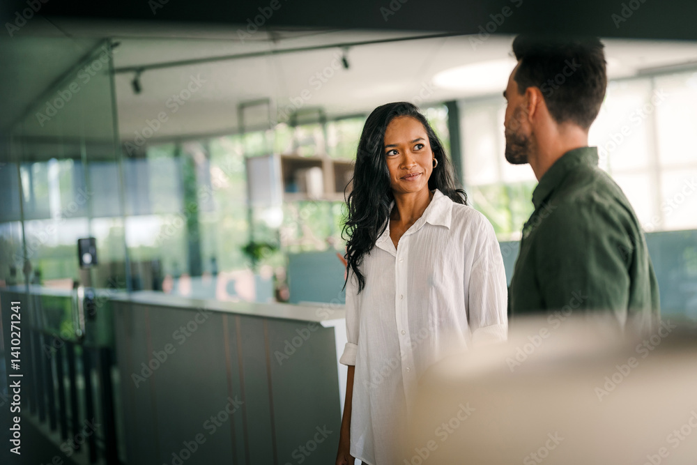 Cheerful diverse coworkers having fun during work break using technology enjoying working together