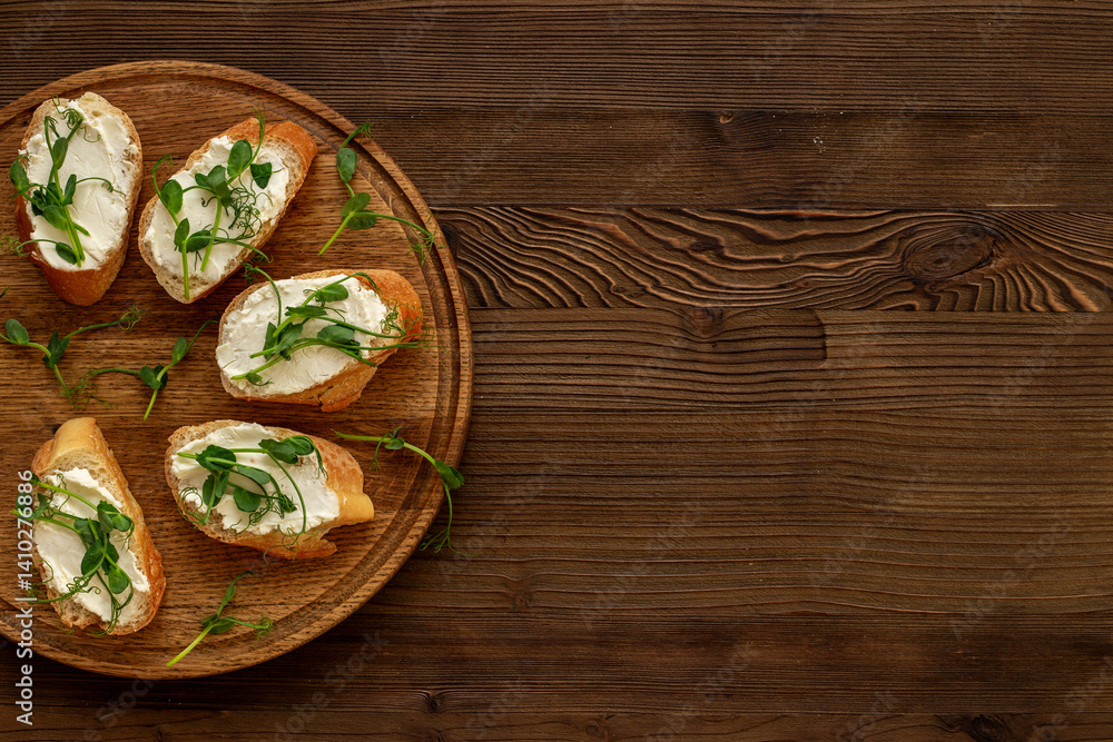 Toasts with with cream cheese and micro greens peas, healthy snack. Top view Toasts with with cream cheese and micro greens peas, healthy snack. Top view