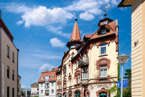 Obraz na płótnie Historic residential buildings with ornate towers and red rooftops in the old town of Gotha, Thuringia under a bright blue sky w salonie