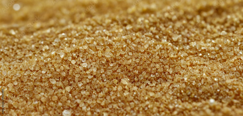 An awe-inspiring close-up view of sand grains magnified under a microscope, revealing an intricate tapestry of delicate textures and patterns.