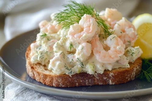 Wallpaper Mural Close-up of a shrimp salad sandwich on a dark gray plate. The sandwich features creamy salad with visible shrimp, dill, and bread. A lemon slice is visible in the background Torontodigital.ca