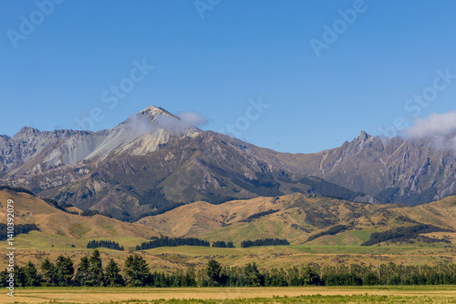 Obraz na płótnie Beautiful rural landscape on highway 94. Mountain range, green fields, and forests. South Island, New Zealand w salonie