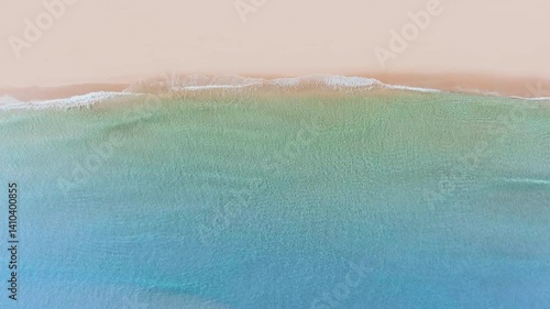 Tropical beach shore aerial view with waves breaking on sand