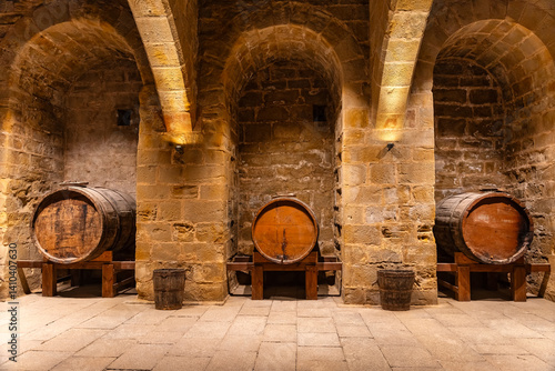 Obraz na płótnie Very old cellars in storage with stone arches and old wooden vats. Teruel, Spain. w salonie