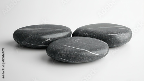 Smooth black stones with white veins arranged on a minimalistic background
