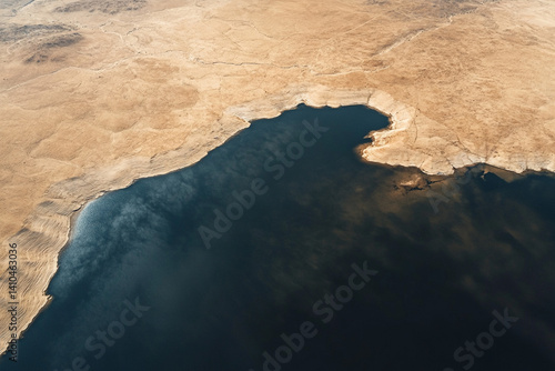 Wallpaper Mural A serene desert lake meeting sun-baked earth, a breathtaking aerial view showcasing earthy tones and deep blue contrasts. Torontodigital.ca