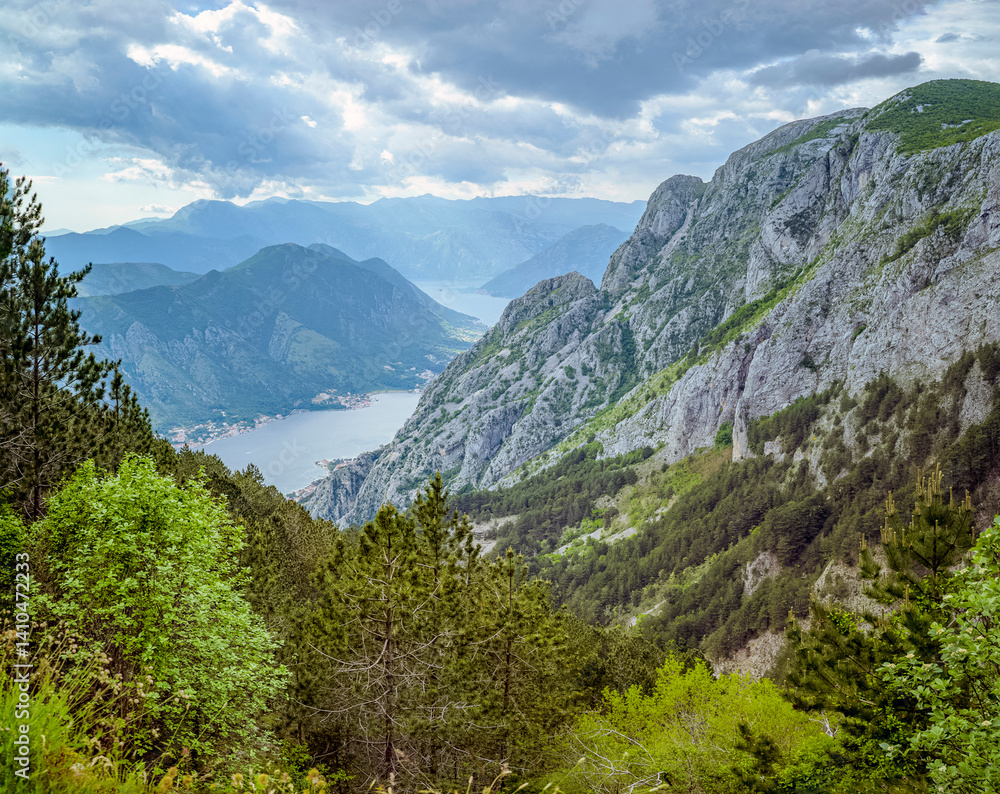 Obraz premium Kotor Bay, Montenegro, Mountainous landscape with a bay and cloudy sky