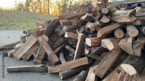 heap of firewood being delivered to home with tractor