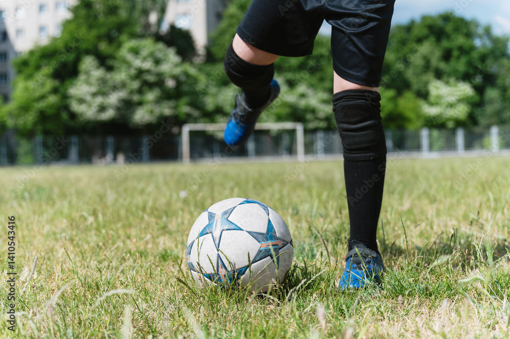Close-up of young football player kicking soccer ball. Close-up of young football player kicking soccer ball.