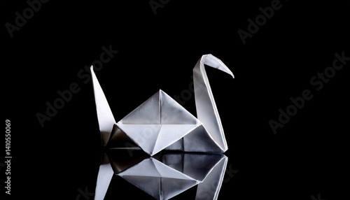 Fototapeta Naklejka Na Ścianę i Meble -  Origami swan against black background: paper craft art reflecting on surface