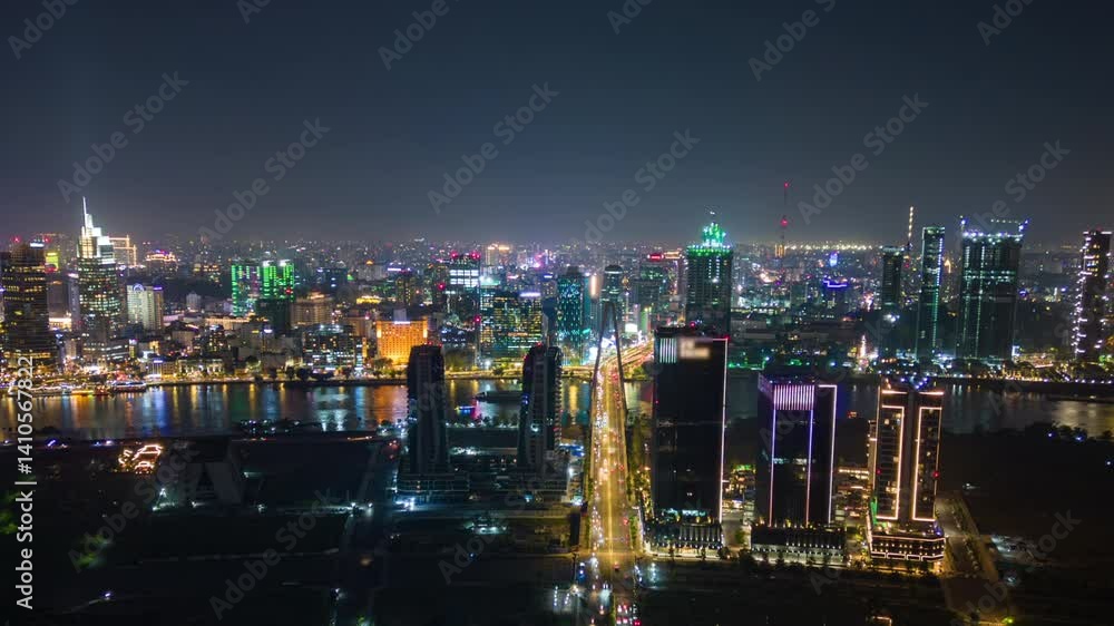 Timelapse aerial view of Ho Chi Minh City (Saigon), Vietnam, at night with glowing skyline, illuminated skyscrapers, and traffic lights reflecting on the river Timelapse aerial view of Ho Chi Minh City (Saigon), Vietnam, at night with glowing skyline, illuminated skyscrapers, and traffic lights reflecting on the river