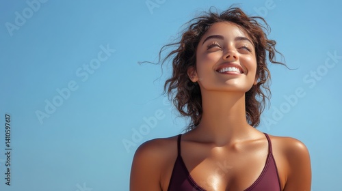 Happy young woman enjoying summer sun with blue sky background