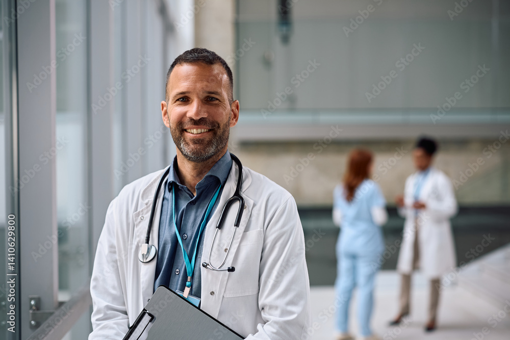 Portrait of happy doctor standing at the hospital and looking at camera. Portrait of happy doctor standing at the hospital and looking at camera.