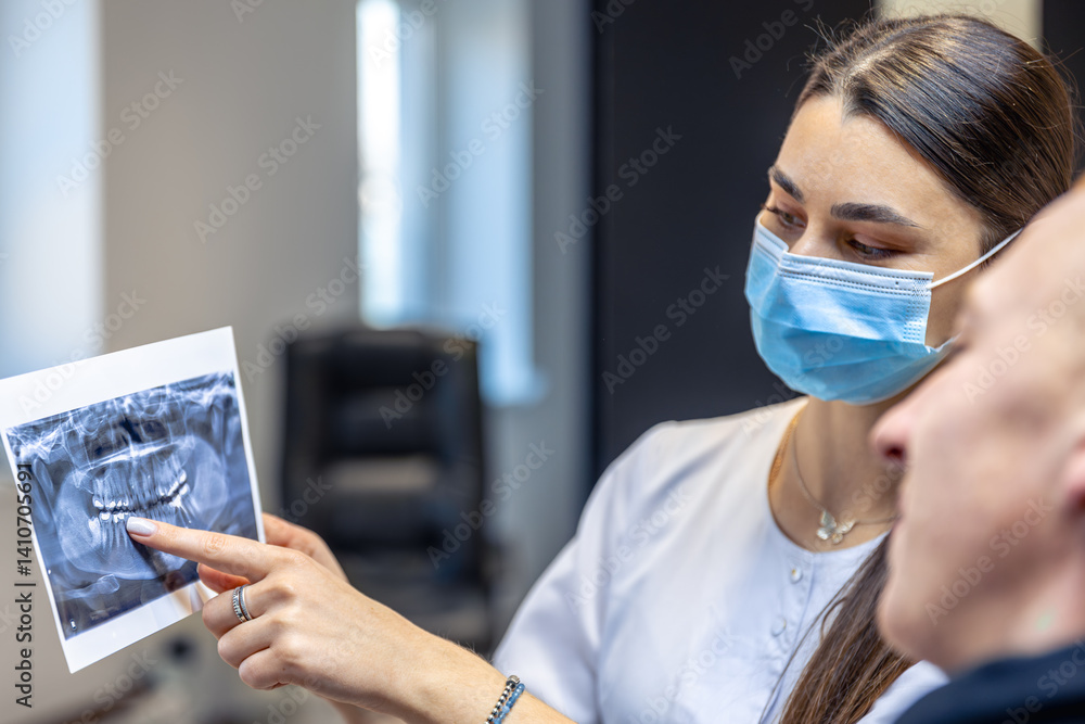 Young female dentist showing a patient a dental x-ray. Dentistry concept. Young female dentist showing a patient a dental x-ray. Dentistry concept.