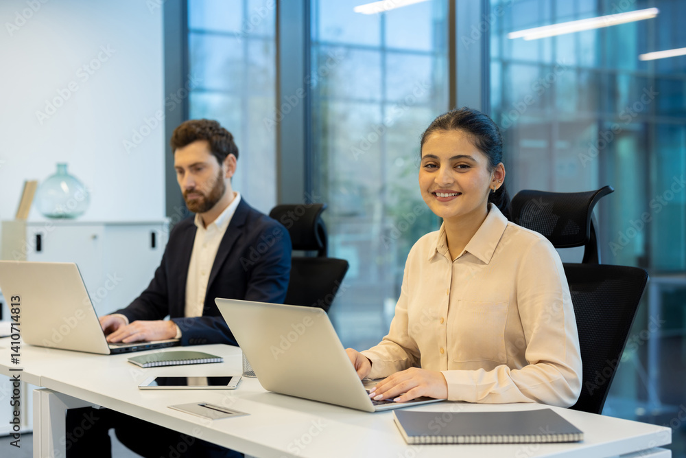 A diverse team works collaboratively on laptops in a modern office environment, focused on productivity and innovation. The image features smiling colleagues. A diverse team works collaboratively on laptops in a modern office environment, focused on productivity and innovation. The image features smiling colleagues.