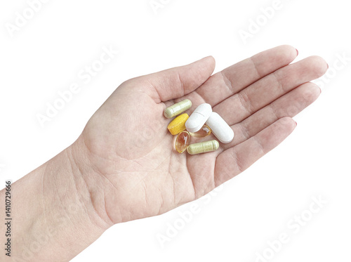 Human hand holding a handful of dietary supplement pills, isolated on transparent background. Variety of bioactive capsules and tablets for health and wellness.