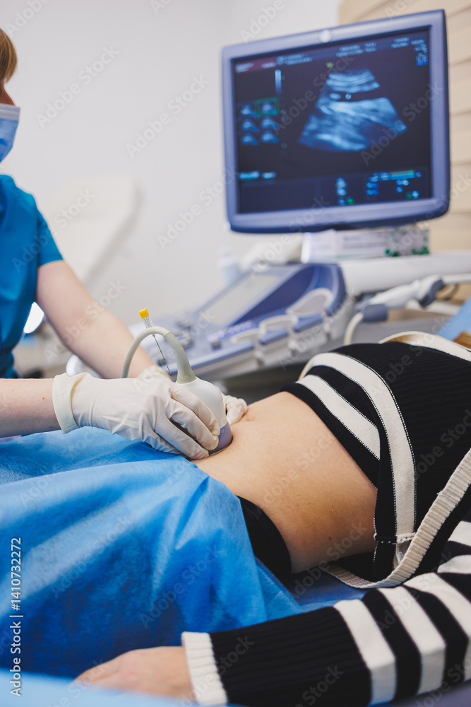 Woman lying near doctor during pregnancy ultrasound. Checking pregnant woman during pregnancy disturbance