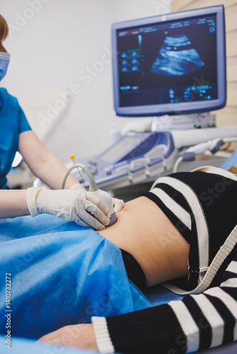 Obraz na płótnie Woman lying near doctor during pregnancy ultrasound. Checking pregnant woman during pregnancy disturbance w salonie