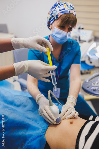 Woman lying near doctor during pregnancy ultrasound. Checking pregnant woman during pregnancy disturbance