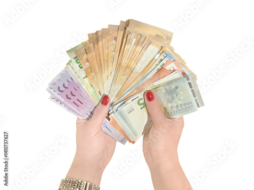 Female hands holding a fan of euro banknotes of various denominations, isolated on transparent background.