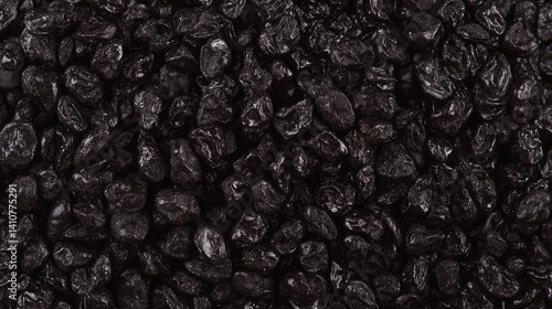 A polished assembly of black lava pebbles, resembling a textured tapestry, is illuminated softly.