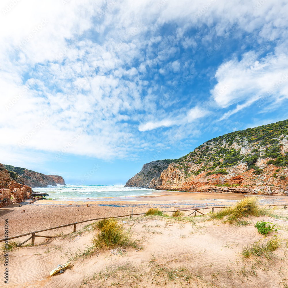 Attractive view of valley Cala Domestica with marvelous sand beach and ruines of old village
