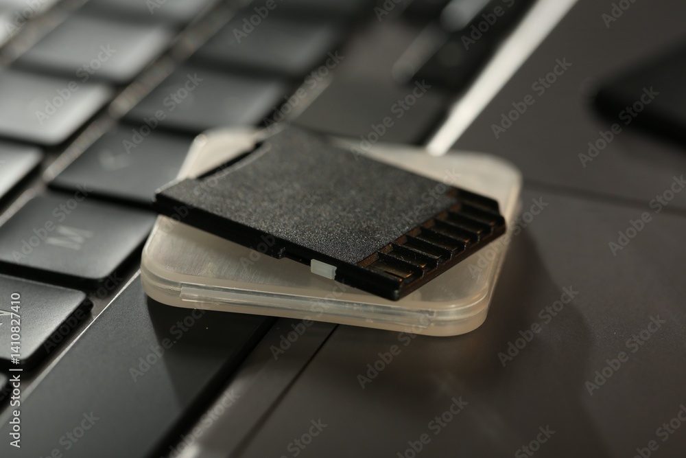 SD memory card and holder on laptop, closeup SD memory card and holder on laptop, closeup