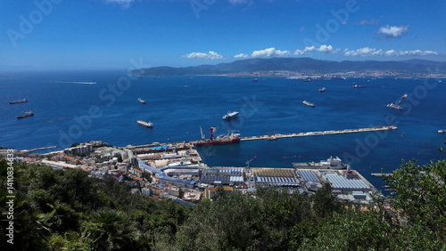 Gibraltar harbor, city and bay embracing cargo ships sailing in the Mediterranean Sea