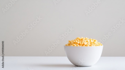 Obraz na płótnie Golden cornflakes in a pristine white bowl, isolated against a clean white backdrop for a minimalist, fresh look w salonie