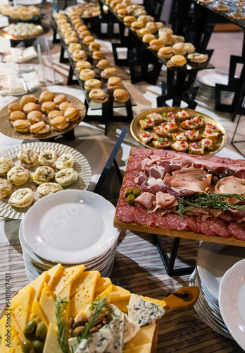 Social event banquet. Finger food. View of the catering self service cold table with a beautiful setting, decoration and plates arrangement