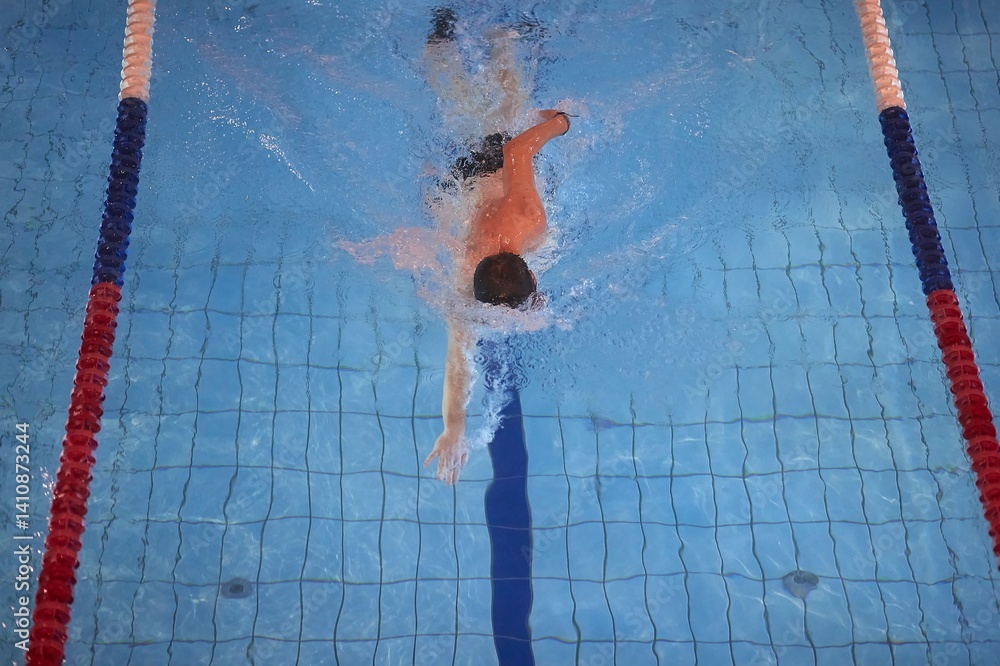 Man swimming in a pool freestyle