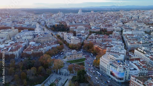 Stunning aerial footage of Madrid during sunset, highlighting the iconic Puerta de Alcal and the vibrant cityscape