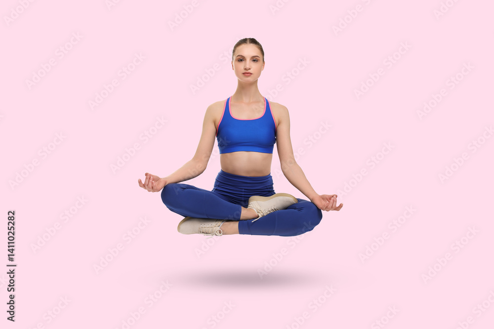 Young woman levitating during meditation on pink background. Practicing yoga Young woman levitating during meditation on pink background. Practicing yoga