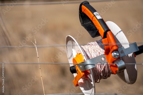Фотография Temporary electric fence with reels and polywire on a rotational grazing cattle