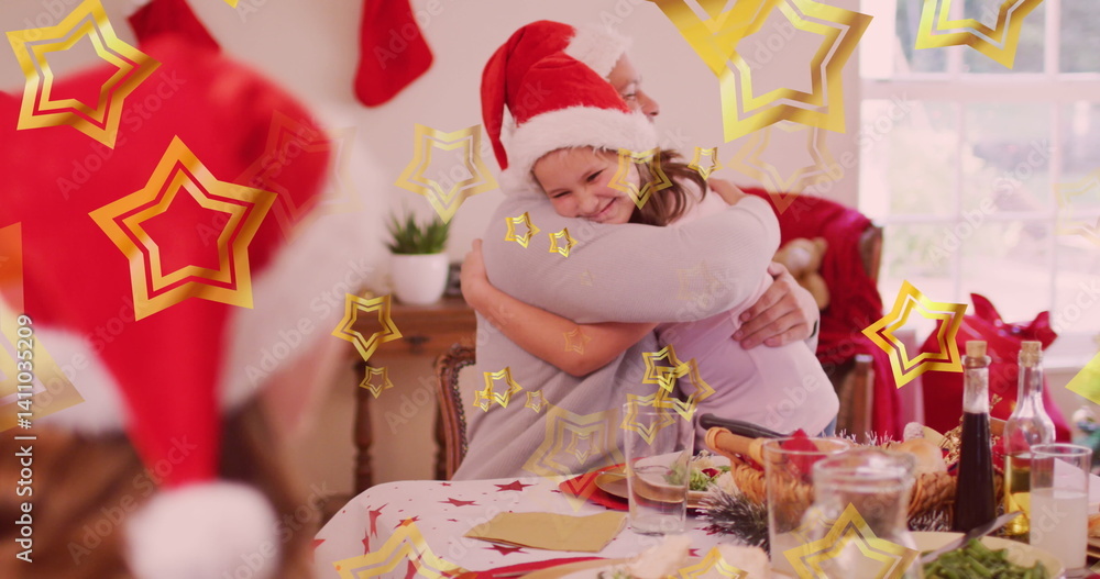 Fototapeta premium Image of stars floating over happy caucasian family wearing santa hats and having dinner