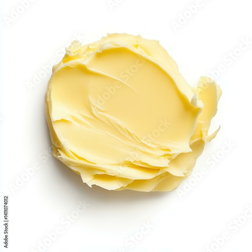 A smooth pat of butter glistens against a  white background, perfect for culinary inspiration.
