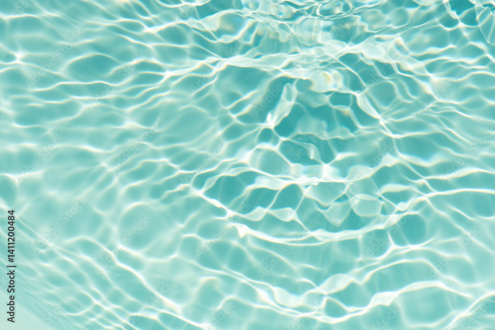 Obraz premium Blue water with ripples on the surface. Defocus blurred transparent blue colored clear calm water surface texture with splashes and bubbles. Water waves with shining pattern texture background.
