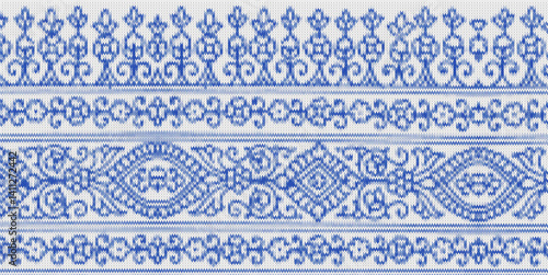 Traditional ornamental floral border pattern in blue with intricate symmetrical details.