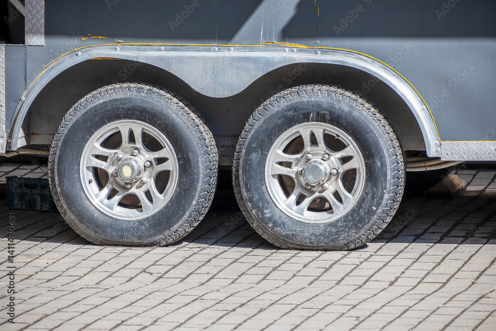 Naklejka premium A fragment of a trailer in the parking lot on a spring day