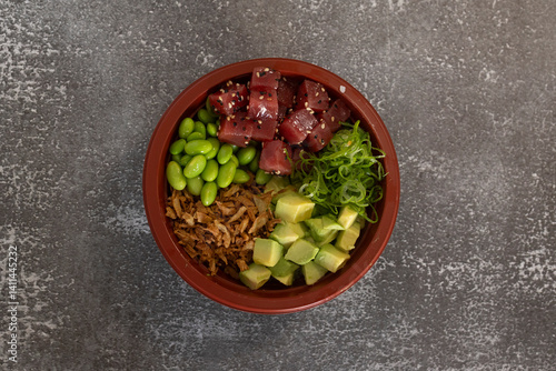 Delicious tuna poke bowl with avocado, edamame, crispy onions and spring onions